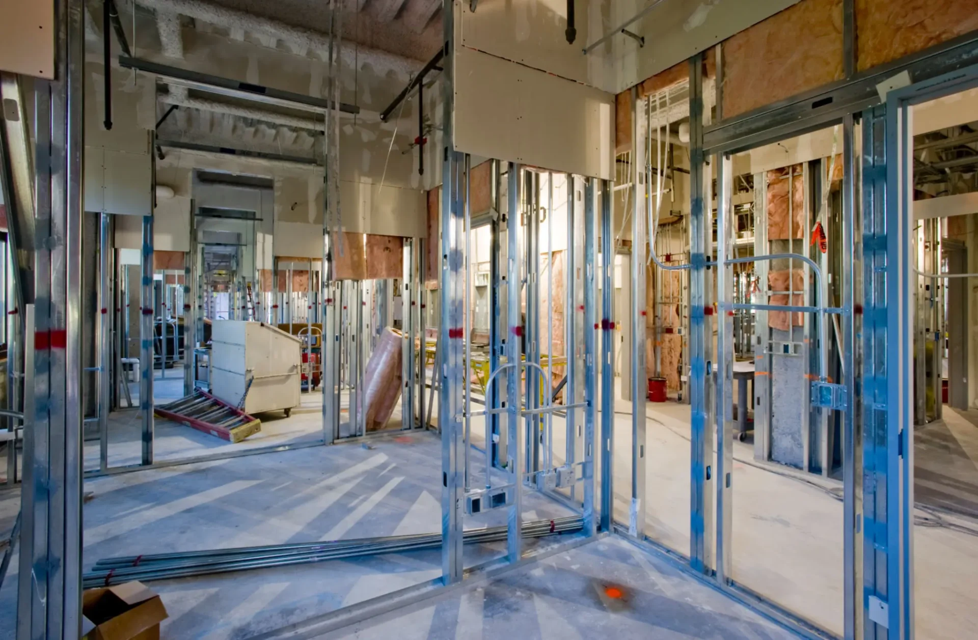 Interior framing of a building under construction with metal studs.