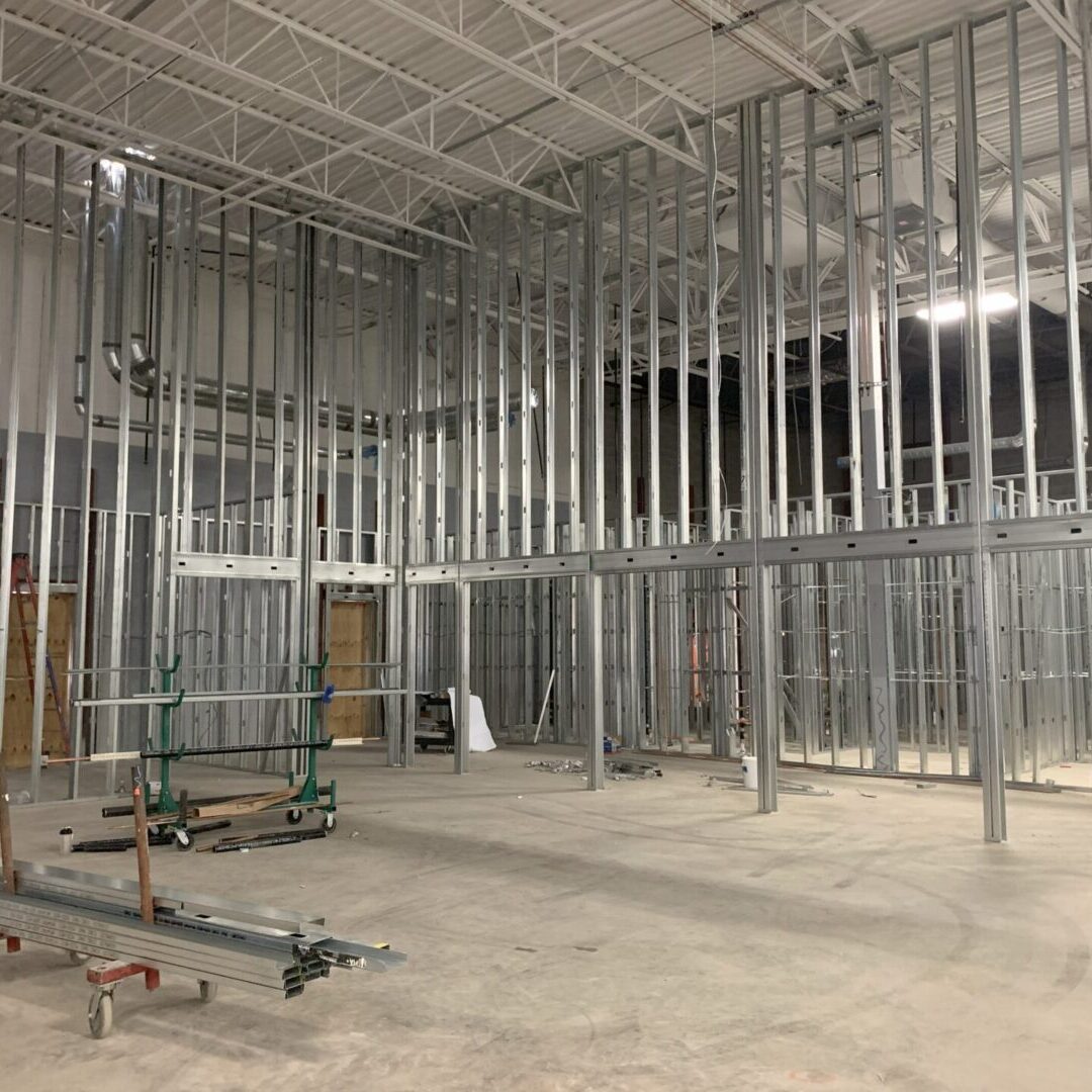 Interior view of a building under construction with metal framing.